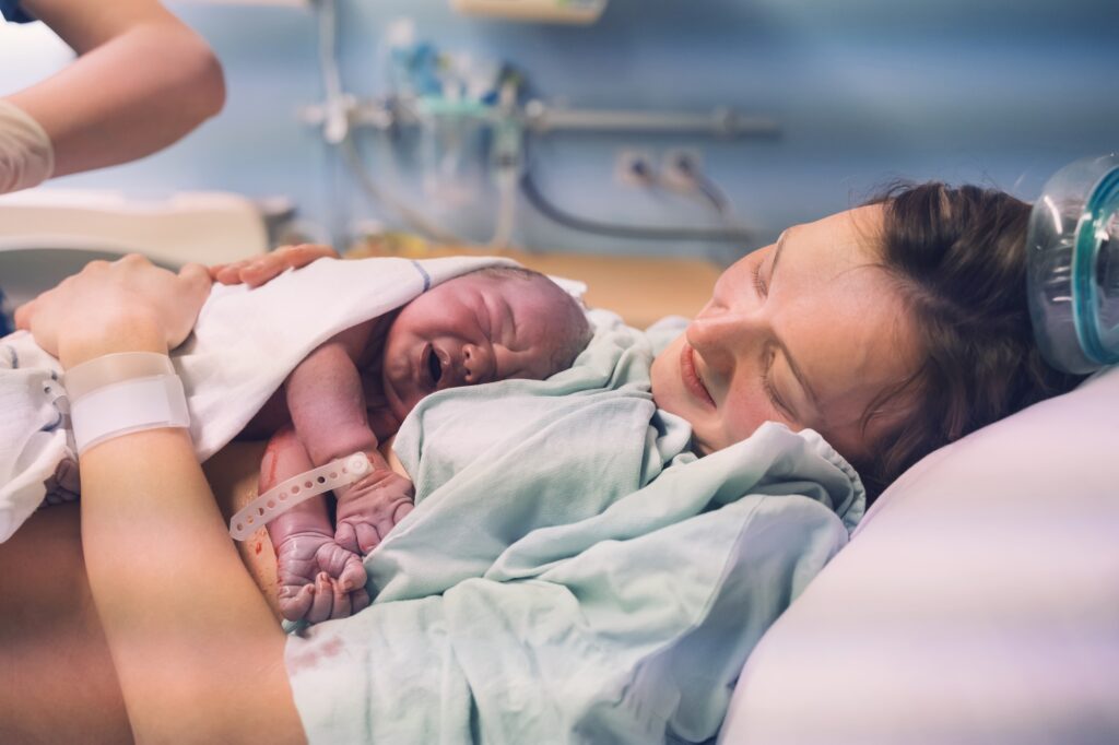 Mother and newborn. Child birth in maternity hospital.